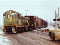 Ontario Paper #4 is shown bringing a cut of pulpwood cars across Allanburg Rd to the paper mill. CN's daily "pulp train" out of Toronto, named obviously for the loads on the head end, has set off these loads about a mile south of the plant. Ontario paper began operations back on Sept 5, 1913. It currently operates as Resolute Forest Products.Dull, miserable day, but a good way to spend Valentine's Day. :o)