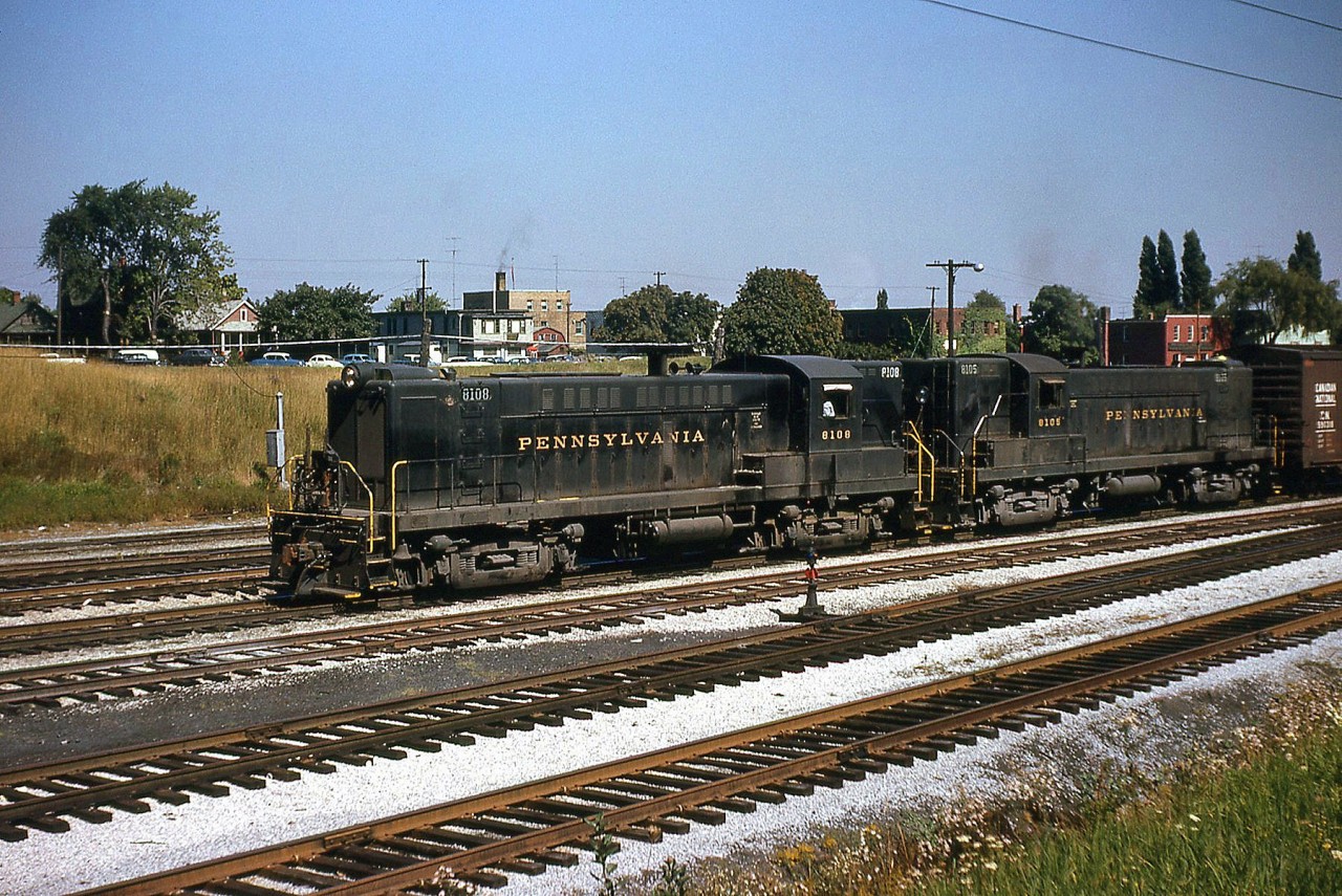 A pair of Pennsylvania Railroad Baldwin RS12's, PRR 8108 and 8105, handle a transfer from Buffalo, arriving on the Canadian side of the border in Fort Erie ON. One would be hard-pressed to find Baldwins operating in service today, much less on a Class 1 Railroad.  Editor's Historical Note: The RS12 (while it sounds like an ALCO designation) was a successor to the DRS4-4-1000 and VO-1000 units produced by Baldwin earlier on, not many of which were produced for Canadian Railways, but occasionally made inroads into Canada via foreign railways.