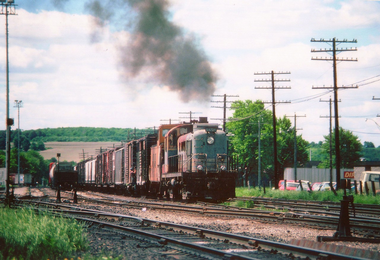 Back in the days when a stable of switchers (and a turntable!) were kept at Woodstock, we see CP 8459 working the west end of the yard.