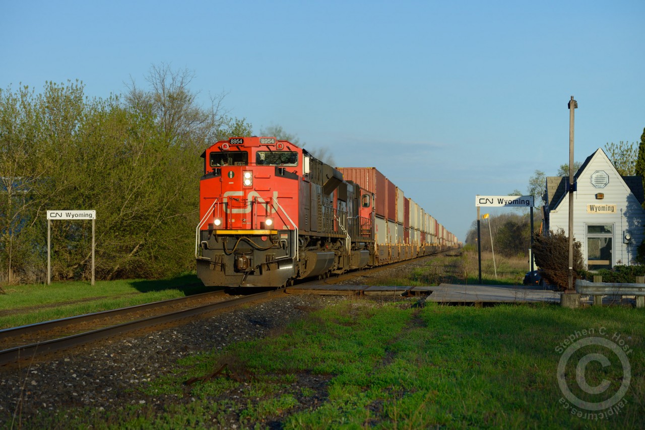 CN Intermodal hotshot 148 passes through Wyoming Ontario - one of the smaller, diminutive towns on the Strathroy Subdivision. VIA does service this small station, but you must reserve in advance, no flag stop permitted here.