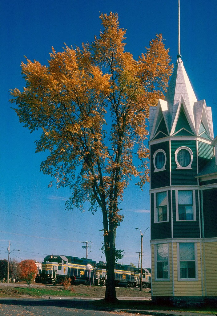 CDAC 905 gets underway after a crew change at Lac-Megantic, Quebec in October of 1997. The house in the forground just escaped the devestation of the MM and A run away oil train derailment of July 6, 2013. Everything, and I mean everything to the right of this home and the third locomotive is gone from the blast of the oil tank cars.