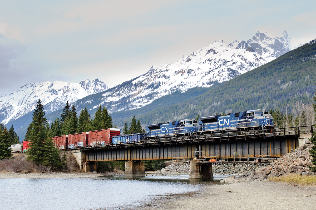 During a (VERY) brief period of sunlight (bright cloud if you will), 2 of CN's 4 recently acquired EMD SD70ACes (8101 and 8102) speed across the Fraser River at Redpass, BC with Vancouver-Winnipeg train M302.