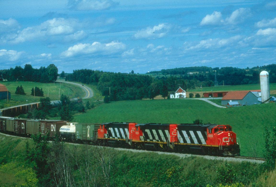 CNR 394 is just below Waterville, Quebec in August of 1987 hustling south toward the US border.