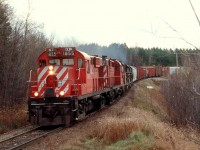 CDAC "905" races upgrade at Racey, Quebec with 2 borrowed CP RS18u's leading 3 Bangor & Aroostock "geeps" eastbound during the early days of the Canadian American Railway.