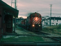 Extra 4209 East hammers through Cookshire, Quebec on a typical dreary day in the eastern townships in April of 1986.