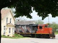 Time is running out for CN 580 on the Burford spur. It is seen here cutting behind the classic homes along the spur to reach the last online customer. Today one car will be dropped off, with two lifted.