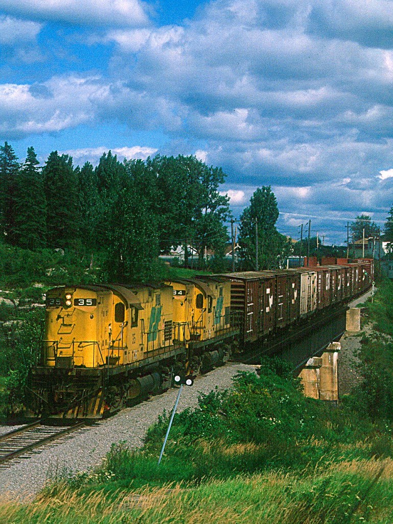 Two R&S Alco C420's roll east through Chitcoutimi, Quebec on a gorgous evening in August of 1988.