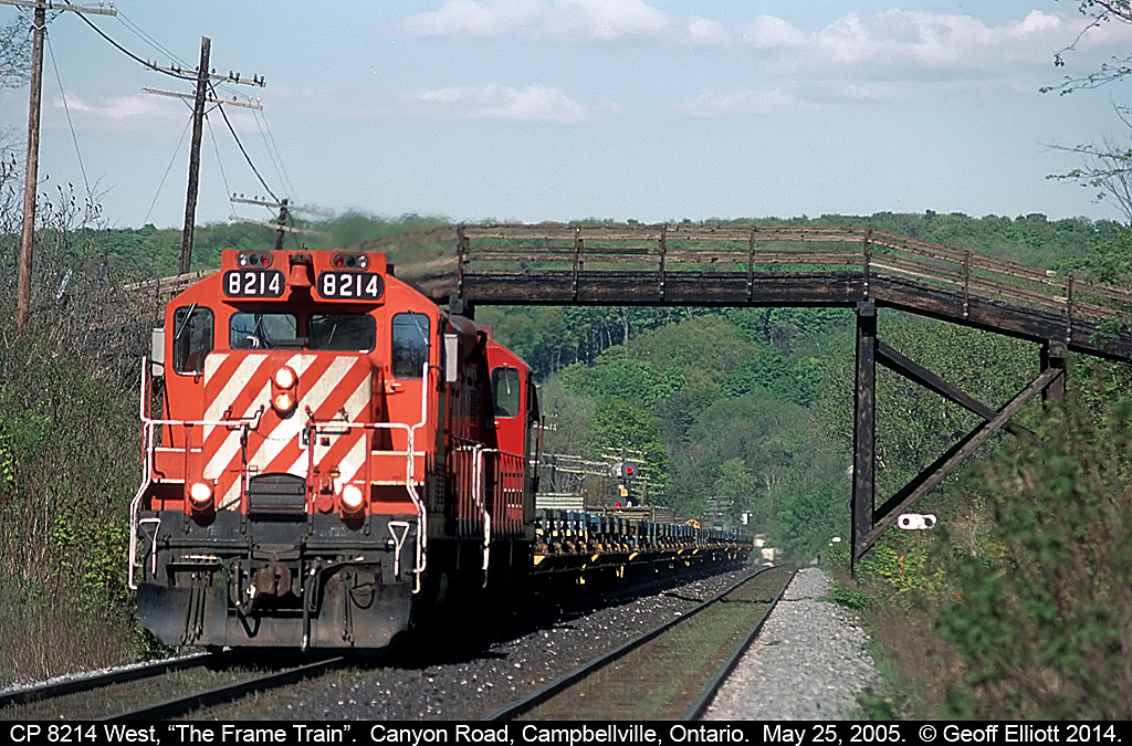 The westbound empty frame train speeds up the grade while heading back to St. Thomas, Ontario after delivering loaded flats of frames to GM in Oshawa.