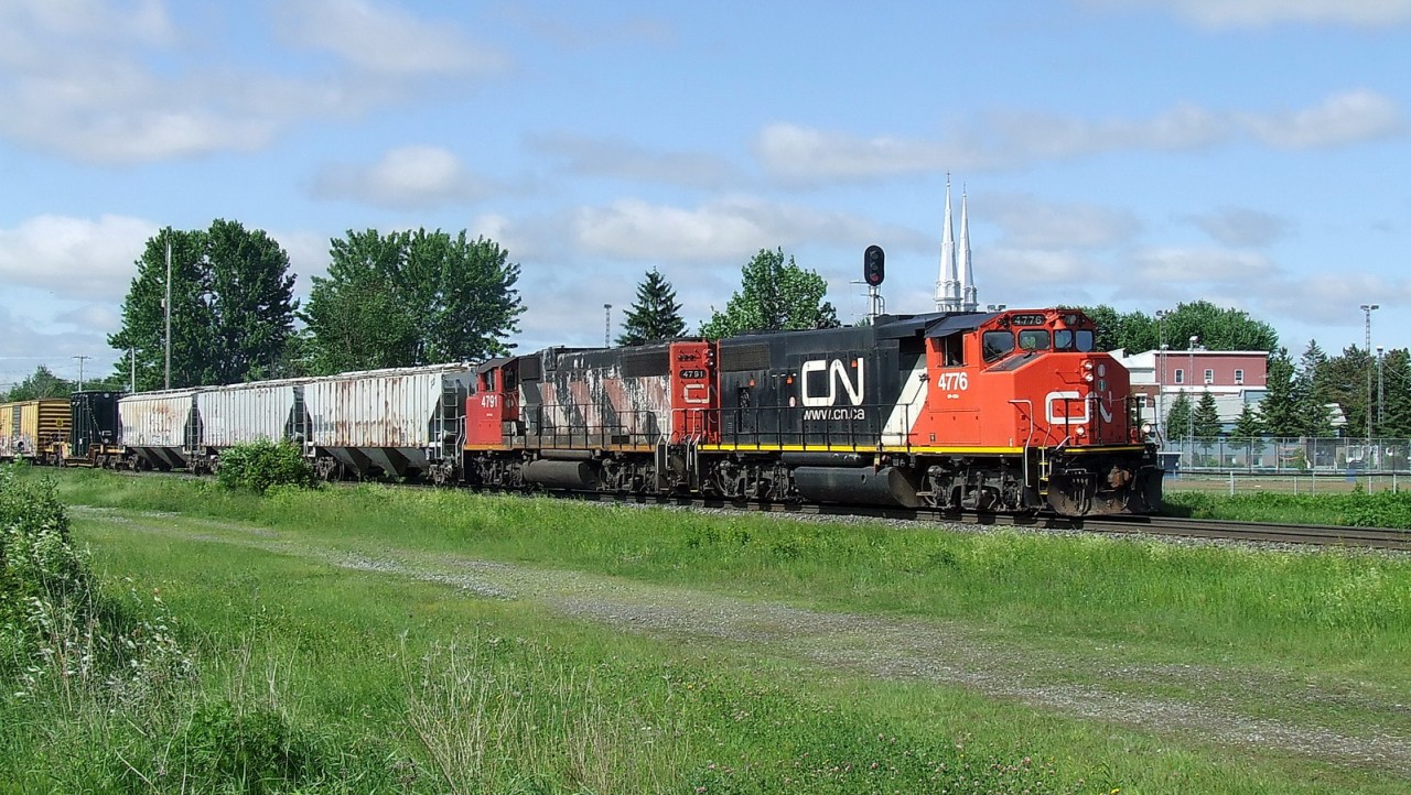 CN 430 with 2 GP-38s,throttle opened wide for the uphill to come at 15 mph.