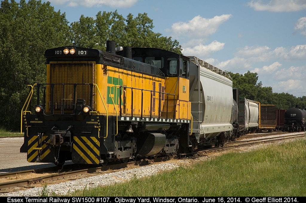 Essex Terminal SW1500 #107 marshalls cars at the west end of Ojibway Yard on a hot and muggy June 16th day......