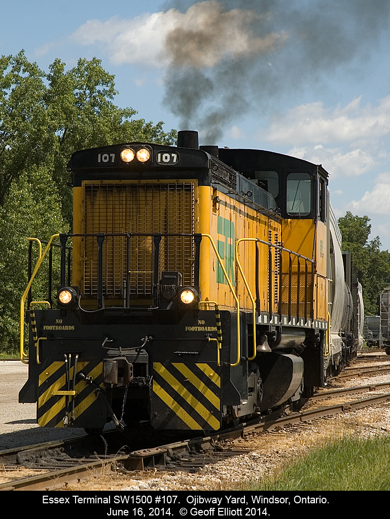 The Engineer on Essex Terminal 107 pours the throttle to the unit to get up some quick speed as the ground crew works to kick cars onto the proper tracks down at the west end of Ojibway Yard.