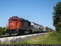 CN train #439 speeds across Chatham/Kent as it is about to cross the Drake Sideroad at "VIA DRAKE" with an SD50 running solo today.  439 is now significantly larger than it used to be now that CN has won the contract for loading autoracks out of the old GenAuto facility in Windsor.