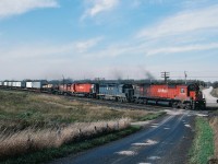...Thirty years ago...
<br>
<br>
...CP Rail was a division of Canadian Pacific Limited (other divisions included CP Hotels, CP Ships, CP Air )
<br>
<br>
….railway  rights of way were shrubbery free and  tree-less...
<br>
<br>
...and lash-ups  were commonly  three  or more  units...
 <br>
<br>
...Alco (MLW) power...was the norm on CP Rail (Eastern and Atlantic Region) – (all those dozens of  new SD's sent west ),
<br>
<br>
An eastbound CP Rail   #942  with TOFC at Lovekin,
<br>
<br>
Powered by Four Units Three Models Two Builders: a  lashup soiled by a single EMD invader:
<br>
<br>
CP Rail #4569 - B&O 3736 – CP Rail  4509 – CP Rail  4236 ( MLW M630 - EMD GP40 - MLW M630 - MLW C424 )
<br>
<br>
B&O 3736 off the Chessie  roster by January 1, 1987 but lived to see CSX: By April 30, 1986 B&O merged into the C&O; then July 1, 1986 C&O was merged into the new CSX Transportation (part of the CSX Corporation)
<br>
<br>
by 1991: 4509 stored unserviceable and  by 1993:  4569 retired  and  4236 is the future 1100
 <br>
<br>
Oct 20 1984 Kodachrome by S.Danko
<br>
<br>
What's interesting: 
 <br>
<br>
CP Limited  sold CP Air in 1987 as part of the merger of Nordair and Pacific Western to form  Canadian Airlines
<br>
<br>
October 3, 2001 Canadian Pacific Limited spin off the remaining Divisions into separate companies and at that time the Canadian Pacific Railway Limited that we know today was created.
<br>
<br>
CP Hotels acquired the Delta and Princess Hotel chains (in 1998) and Fairmont chain (1999) then  changed name – in October 2001 to Fairmont Hotels and Resorts and in January 2006 Fairmont was acquired by Kingdom Hotels ( Saudi Arabia owned ).
<br>
<br>
CP Ships Limited ( at that time THE major source of CP Rail's container traffic )  was sold in 2005 to TUI AG (Germany) who merged CP Ships into the Hapag-Lloyd division.
<br>
<br>
<br>
> and the clear view at the Lovekin crossing  today !
<br>
<br>
<a href="http://www.railpictures.ca/?attachment_id=15329">  Stephenson Road 2014 </a> 
<br>
<br>
sdfourty