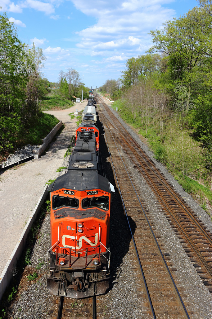 One day before my birthday I decided to head out to the Burlington area and spend a day out at Bayview Junction at Snake. That day is also the day I discovered "high sun" and I found out why so many photographers despise of it. As the day was winding down to an end, we spot CN 435 working Aldershot yard, and not long after, it makes it's way out onto the mainline, picking up the conductor, and heading out under Snake. This is one of the first photos I have uploaded in a long time, and I'm glad to be back and posting on this wonderful site!