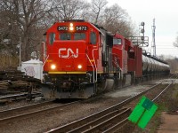 A pair of canadian rivals (CN 5472 - CP 9377) leading U721 with 94 cars over the newly replaced switches at Brantford