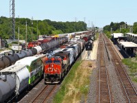 CN 435 slowly pulls into Aldershot for a tail-end drop and lift; note recently repainted GO coach 2431 in thw new Metrolinx paint en route from CAD to Willowbrook. The trailing unit on 435, BCOL 4606 would require some attention from CN mechanical personnel slightly delaying their westbound trip. The train then encountered a bigger delay when it stalled part way up the hill to Copetown, when the 11,000 feet proved too much for the two engines. For the second day in a row, CN 551 would be called out to give the train a push up the grade. As Tim Allen would say, they needed "More Power!"