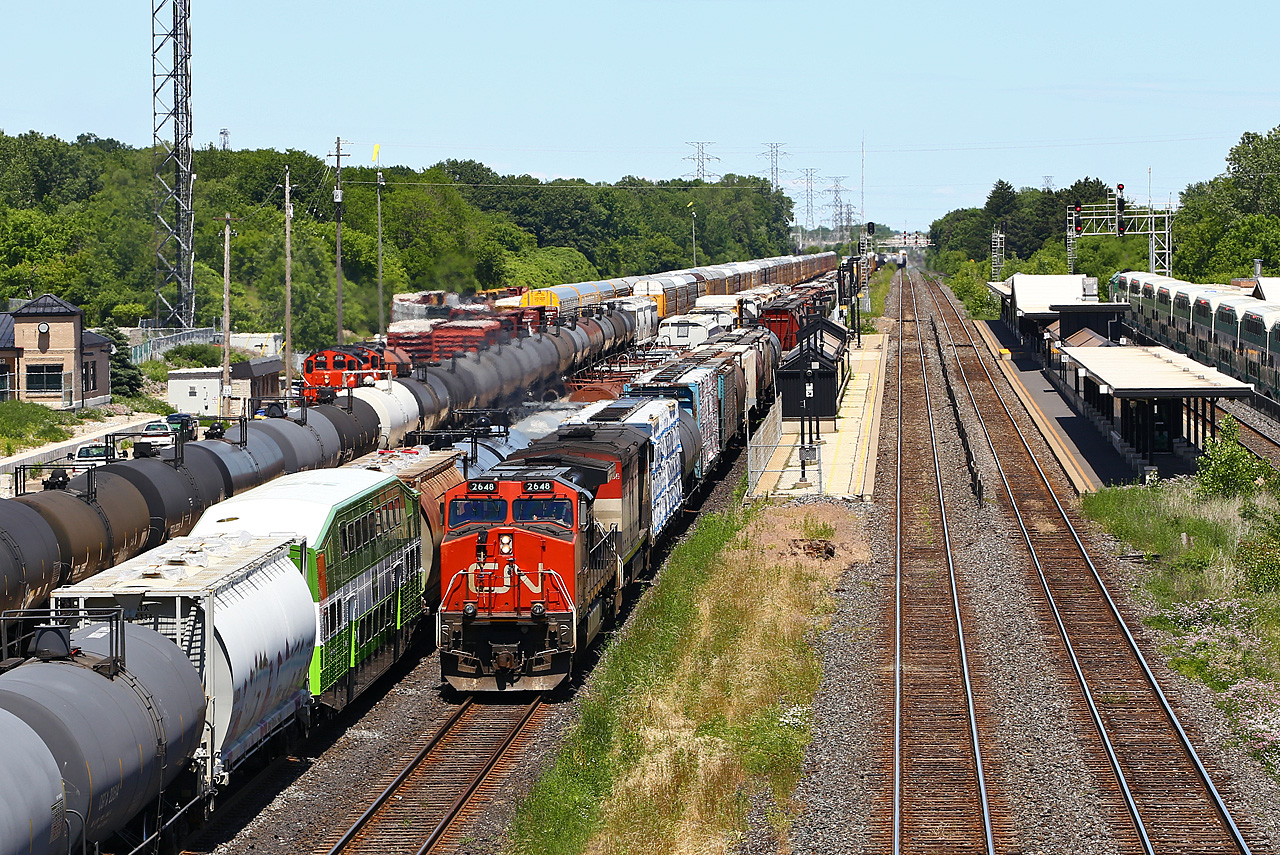 CN 435 slowly pulls into Aldershot for a tail-end drop and lift; note recently repainted GO coach 2431 in thw new Metrolinx paint en route from CAD to Willowbrook. The trailing unit on 435, BCOL 4606 would require some attention from CN mechanical personnel slightly delaying their westbound trip. The train then encountered a bigger delay when it stalled part way up the hill to Copetown, when the 11,000 feet proved too much for the two engines. For the second day in a row, CN 551 would be called out to give the train a push up the grade. As Tim Allen would say, they needed "More Power!"
