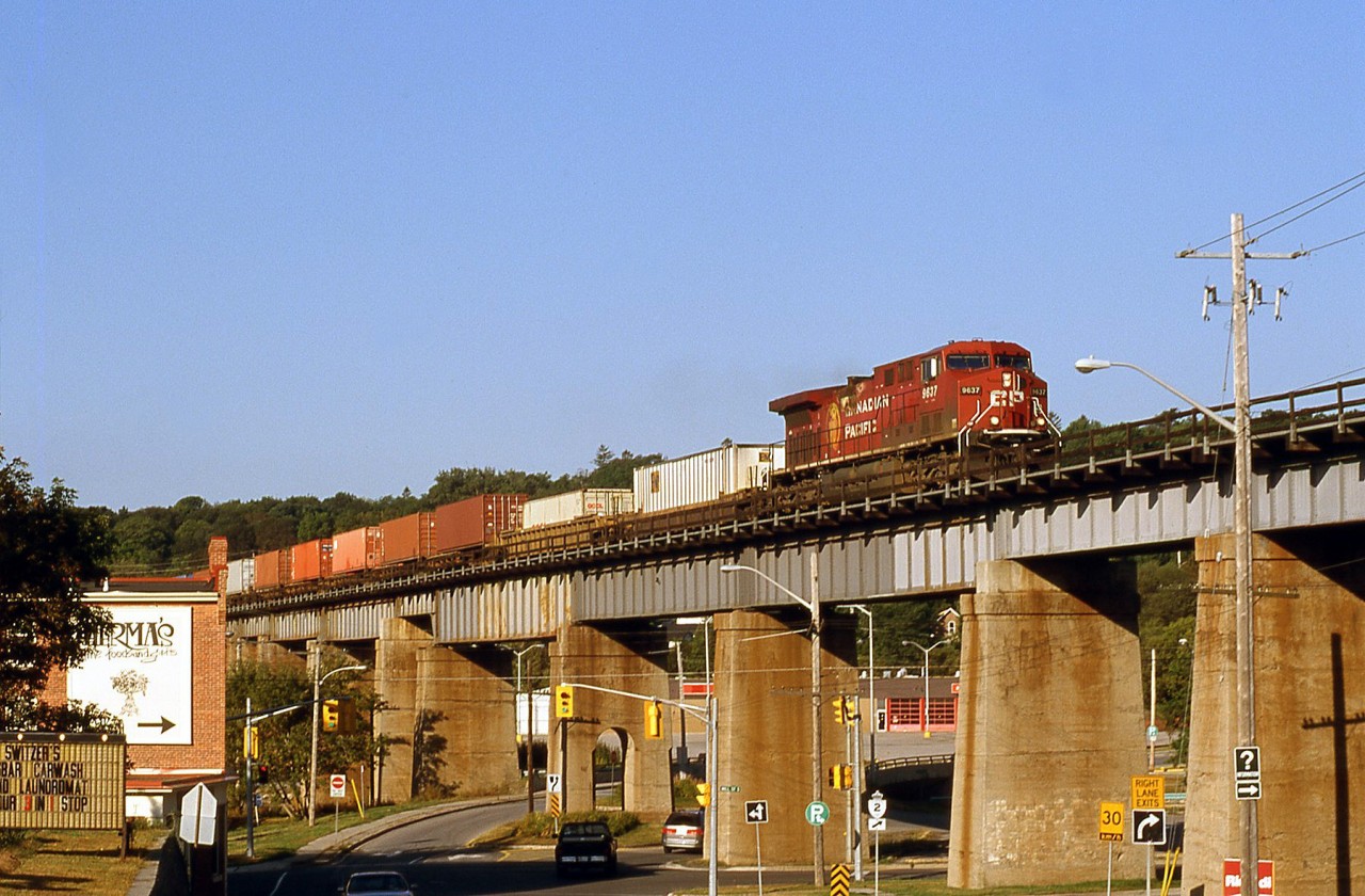 An eastbound CP intermodal train lead by AC4400CW 9627 crosses the viaduct above the goings-on in the town of Port Hope below.