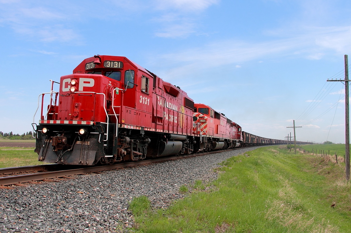 A westbound ballast extra with three different EMDs round a curve just west of Tapley siding.