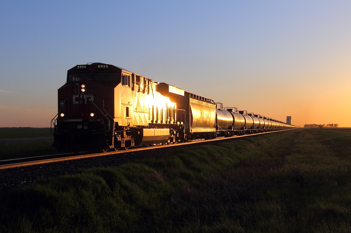 CP 8924 leads crude oil loads through Meadows at sunset.