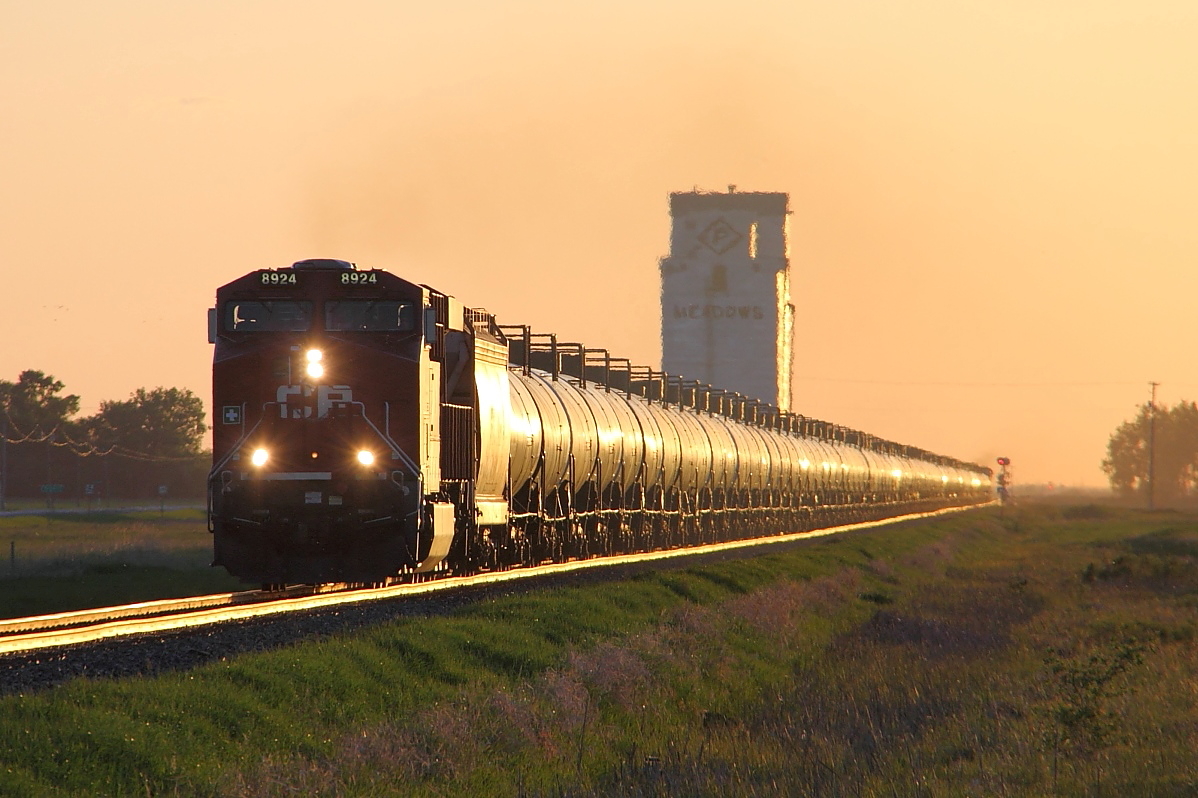 Crude oil loads pass the old elevator at Meadows.