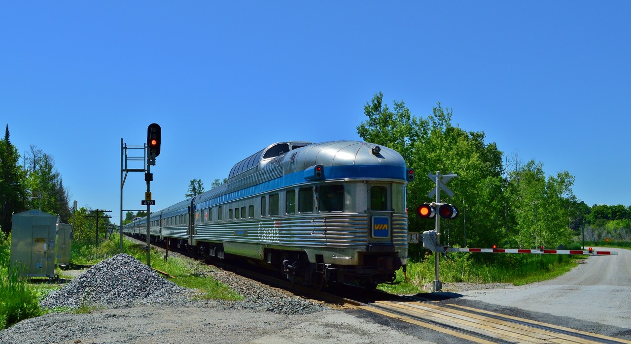 Just another Canadian.


 Or is it?


 Please do consider how exceptional this Train is. 


 And the fact this Train exists at all.


 [especially given the anti passenger rail attitude(s) of many present and past government(s) and possibly future government(s)].


 Via's Flagship train #2 at 12:43 on southbound approach to CN Zephyr, Bala Sub  mile 47.0 (mile 46.9 northbound). 


 Via's arrival hotline reported #2 expected at 12:55 and with another 47 miles to go, make that a likely 13:55 Union arrival, possibly four hours twenty five minutes off the advertised.


 And today the time is exceptional (hopefully not regular) – and the noon hour light is a challenge.


 Re-built F40PH-2, class GPA30H #6439 - #6401 on the head end (hence the tail end shot – fewer Park's around than F40PH-2's)


 June 26, 2014 digital by S.Danko.


What's interesting:


Sixty years after: Budd built Yoho Park continues daily duty - today on the tail end along with other venerable Budd built equipment on #2 including: sixty six year old Coach 8144 (ex CR (NS) 5678; ex Amtk 5678; ex PC 4053; ex PRR 4053, ex NYC2925 (built 1948)), along with sixty year old Budd built for CPR: Fraser Manor and Dining Room Empress.


The box below the CN signal 470 is an arrow lamp pointing left – that will light when necessary -  to alert a crew that their southbound is  required to take the siding – on the east side of the main -  at Zephyr.


More Via Canadian:


    #1410 at Bradford  


      CP#8529-8473 at Bathurst Street  


      CP colours at Washago  


   at Maple  


And do make the effort to photograph and ride this train, 'cause who knows how much longer the Via Canadian will be...


sdfourty