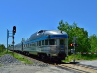  Just another Canadian.
<br>
<br>
 Or is it?
<br>
<br>
 Please do consider how exceptional this Train is. 
<br>
<br>
 And the fact this Train exists at all.
<br>
<br>
 [especially given the anti passenger rail attitude(s) of many present and past government(s) and possibly future government(s)].
<br>
<br>
 Via's Flagship train #2 at 12:43 on southbound approach to CN Zephyr, Bala Sub  mile 47.0 (mile 46.9 northbound). 
<br>
<br>
 Via's arrival hotline reported #2 expected at 12:55 and with another 47 miles to go, make that a likely 13:55 Union arrival, possibly four hours twenty five minutes off the advertised.
<br>
<br>
 And today the time is exceptional (hopefully not regular) – and the noon hour light is a challenge.
<br>
<br>
 Re-built F40PH-2, class GPA30H #6439 - #6401 on the head end (hence the tail end shot – fewer Park's around than F40PH-2's)
<br>
<br>
 June 26, 2014 digital by S.Danko.
<br>
<br>
What's interesting:
<br>
<br>
Sixty years after: Budd built Yoho Park continues daily duty - today on the tail end along with other venerable Budd built equipment on #2 including: sixty six year old Coach 8144 (ex CR (NS) 5678; ex Amtk 5678; ex PC 4053; ex PRR 4053, ex NYC2925 (built 1948)), along with sixty year old Budd built for CPR: Fraser Manor and Dining Room Empress.
<br>
<br>
The box below the CN signal 470 is an arrow lamp pointing left – that will light when necessary -  to alert a crew that their southbound is  required to take the siding – on the east side of the main -  at Zephyr.
<br>
<br>
More Via Canadian:
<br>
<br>
   <a href="http://www.railpictures.ca/?attachment_id=7292"> #1410 at Bradford </a> 
<br>
<br>
     <a href="http://www.railpictures.ca/?attachment_id=2439"> CP#8529-8473 at Bathurst Street </a> 
<br>
<br>
     <a href="http://www.railpictures.ca/?attachment_id=9804"> CP colours at Washago </a> 
<br>
<br>
  <a href="http://www.railpictures.ca/?attachment_id=7285"> at Maple </a> 
<br>
<br>
And do make the effort to photograph and ride this train, 'cause who knows how much longer the Via Canadian will be...
<br>
<br>
sdfourty
