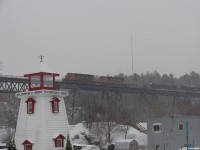 In a setting typically seen more towards the summer months, CN 5335 and CN 5275 hustle CN 303's train across the iconic Parry Sound trestle during some light flurries courtesy of Georgian Bay. 