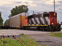 CN 4777 has 40 empty racks in tow as he heads for a loading facility near Jefferosn Ave. and The E.C. Row. CN has recently picked up the switching contract for Chrysler from CP and this is one of many daily locals out of Van de Water Yard that will traverse the City with auto Traffic for Chrysler. 