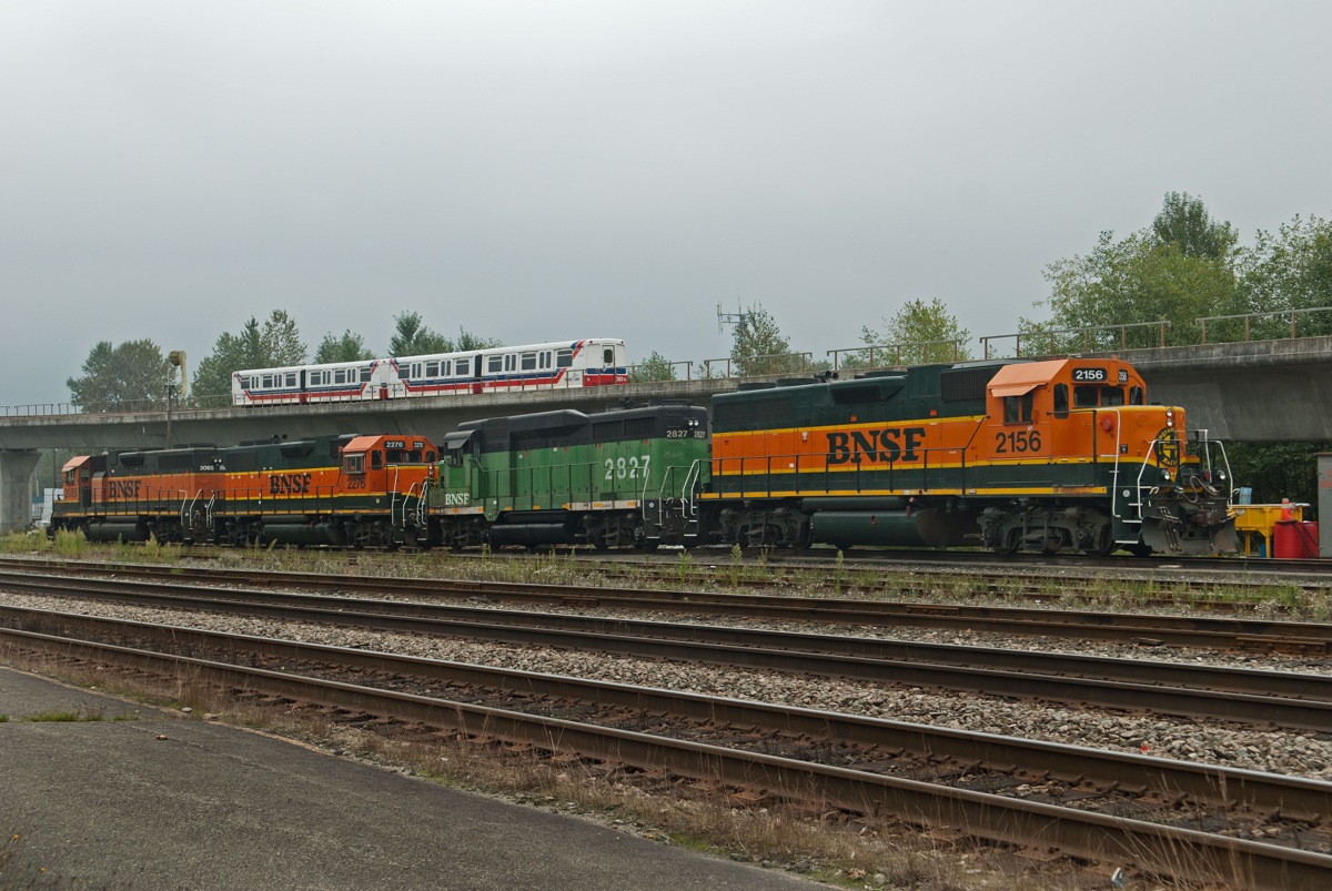 Vancouver's "Sky Train" passes some parked BNSF road switchers on a typically cloudy Vancouver afternoon.
