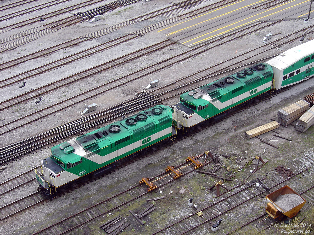Pre-double enders and MP40's of the present day, GO Transit ran certain Lakeshore corridor trains with twin F59's to better keep schedule on weekends. Some of those sets made it out on weekdays to: The first GMD F59PH built, 520, leads (or trails in this case) sister 531 as they shove Lakeshore line train 919 into Toronto's Union Station in the afternoon.

Crossing over nearby Yonge Street viaduct, the tracks below the power were used for TTR maintenance storage and were formerly the leads into the CP Express building/sheds to the east of the station (demolished around 2001 for the new GO bus terminal). Today that land and some surrounding has been sold off to a developer, the 3 tracks taken up, and another condo/office complex is under construction right next to the rails here.