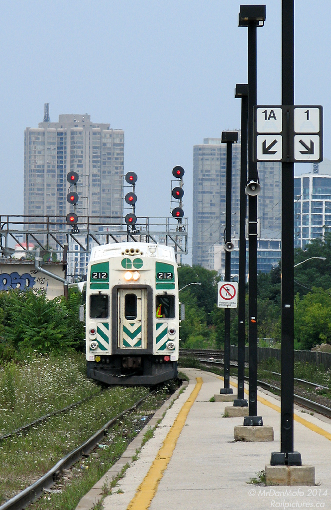 GO cab car 212 prowls the weed-grown Willowbrook Yard lead, heading through the north platform of Mimico GO Station out of service. Note how tightly the platform narrows in the background between the two tracks...I wouldn't want to be standing there when a VIA blows by at track speed!