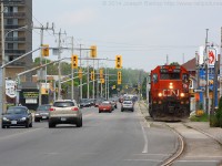 CN 4721 trundles down the Burford Spur with some traffic for Ingenia.  They are seen paralleling Clarence Street through downtown Brantford, shortly they will stop to trigger the traffic lights to allow them to cross over the short street running portion of the spur and continue on to Ingenia.