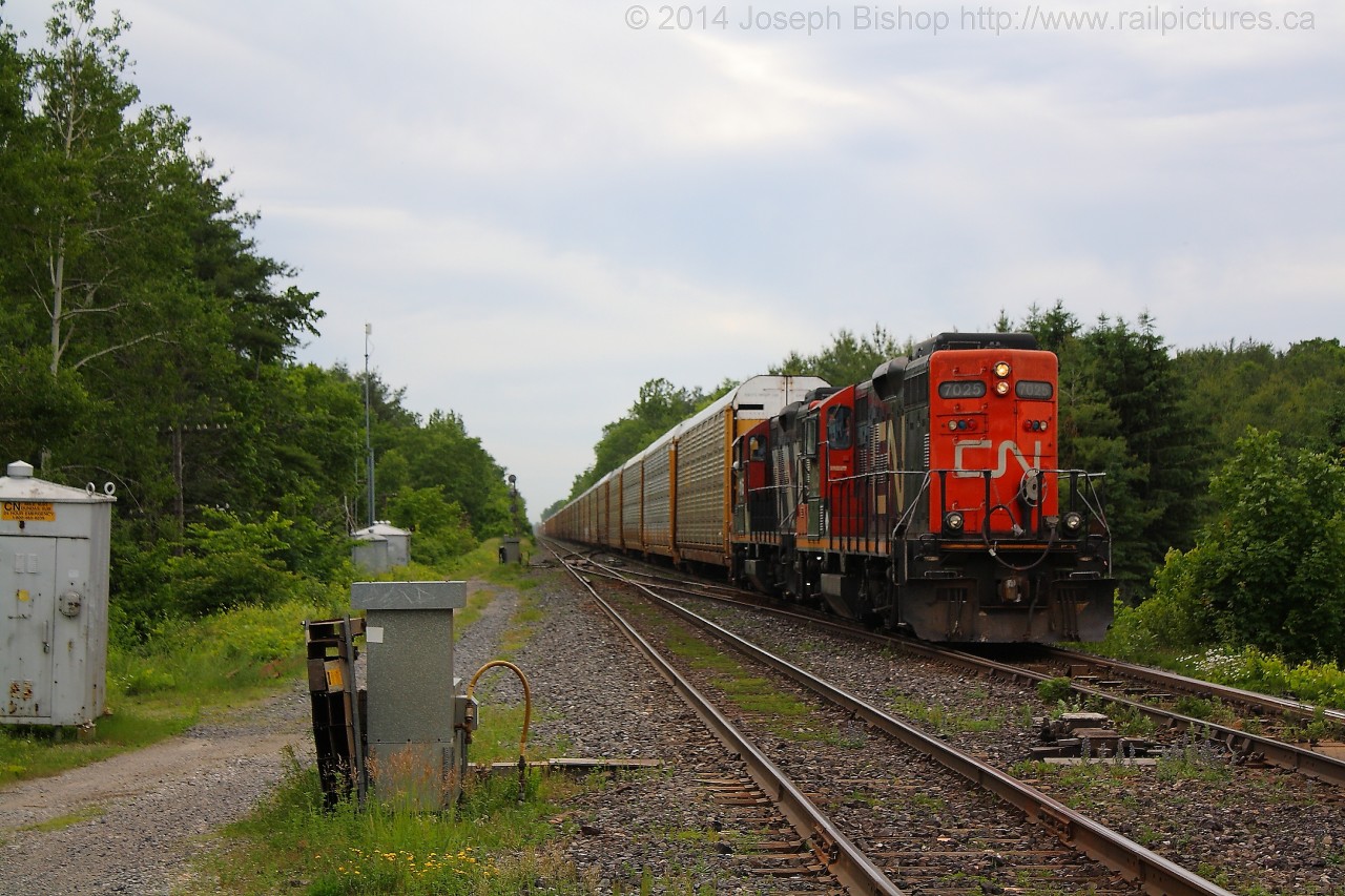 Who you going to call?!?!    In the case of CN 435 they had to call on the assistance of CN 551 from Aldershot to help them get up the grade from Bayview to Copetown.  In this shot CN 551 has just cleared the crossing at Orkney Road and 551 is shoving hard to get 435 clear of the signals at Copetown West.  They will soon stop and cut off of 435 before returning back to Aldershot light power.