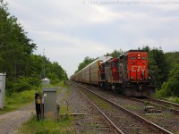 <b>Who you going to call?!?!</b>  <br> <br> In the case of CN 435 they had to call on the assistance of CN 551 from Aldershot to help them get up the grade from Bayview to Copetown.  In this shot CN 551 has just cleared the crossing at Orkney Road and 551 is shoving hard to get 435 clear of the signals at Copetown West.  They will soon stop and cut off of 435 before returning back to Aldershot light power.