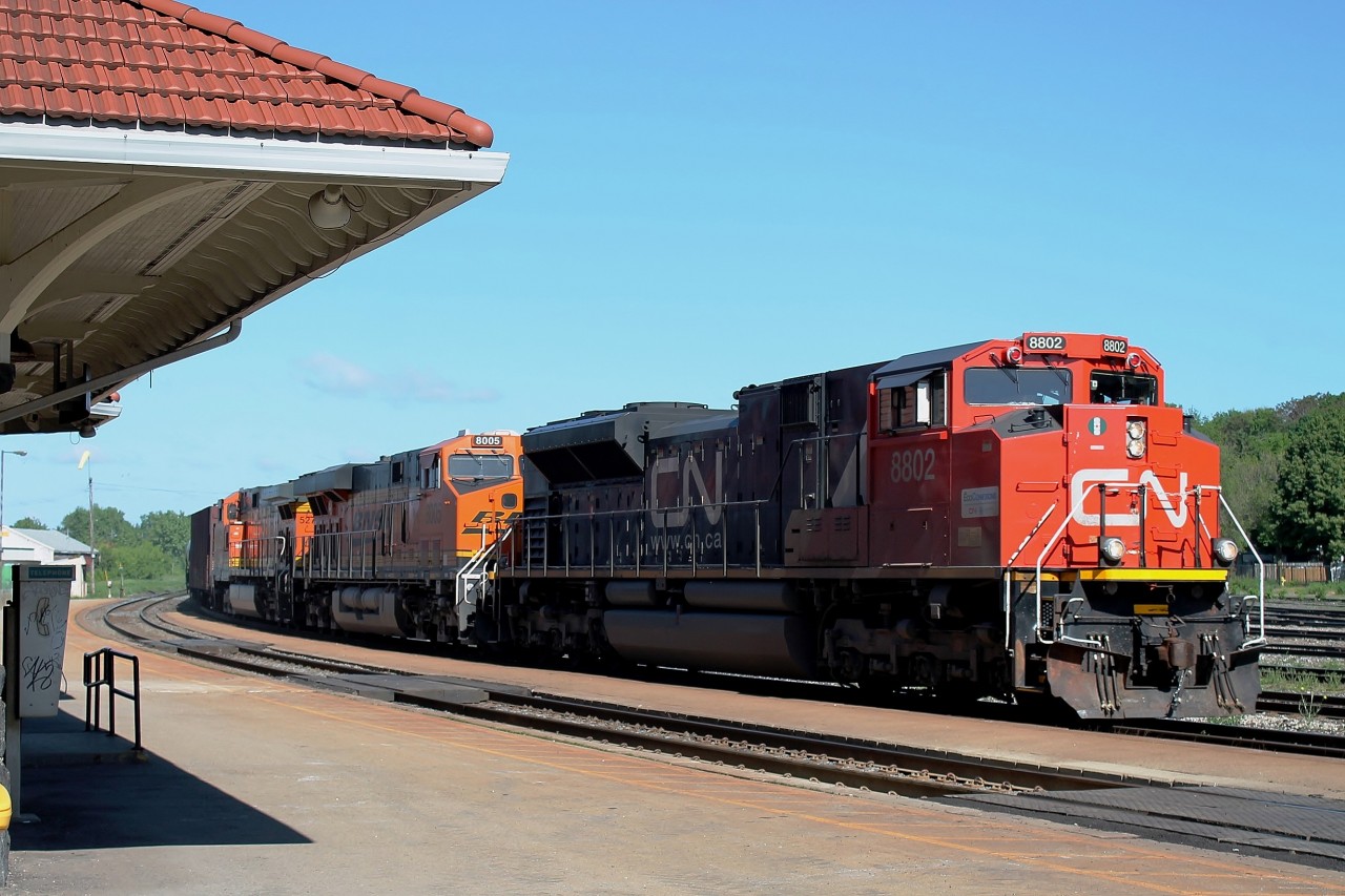 9:50 and an early running oil train heading directly into the strong morning sun. CN 8802 BNSF 8005 and BNSF 5275 are in charge of the long train.