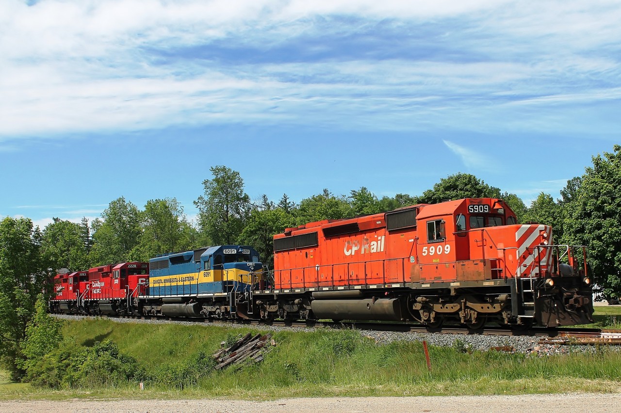 11:06 at highway 3 crossing to the north of Drumbo town centre near the pond. CP5909, DME 6091, CP 2228 and CP 2263 lead an eastbound mixed freight that had a piece of everything!