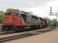 9:45 on a hot, humid, overcast day, two SD60 of different styles, 5537 and 5455 lead 711 west with a string of tank cars. 5537 has the map of North America on the side instead of the usual zebra stripes!