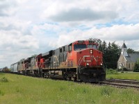 13:46 A mixed freight with a lot of Cargill hoppers and tank cars move quickly up the bank eastbound at Princeton.