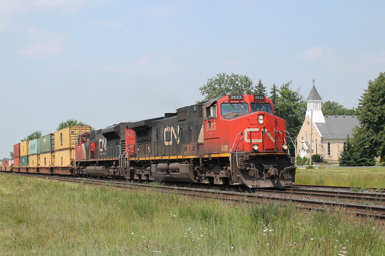 On a hot humid day in Princeton, 2623 and 8919 speed up the bank on the north track with an all intermodal train.