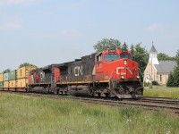 On a hot humid day in Princeton, 2623 and 8919 speed up the bank on the north track with an all intermodal train.