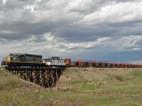 Storm clouds build as the fully loaded rail train removing rail along the CN Drumheller Sub makes it's way back towards Drumheller for the night. This load of rail was from around Delia Alberta. Sad, but interesting to see how they remove the rail. No trains on this part of the line since about 2009. 