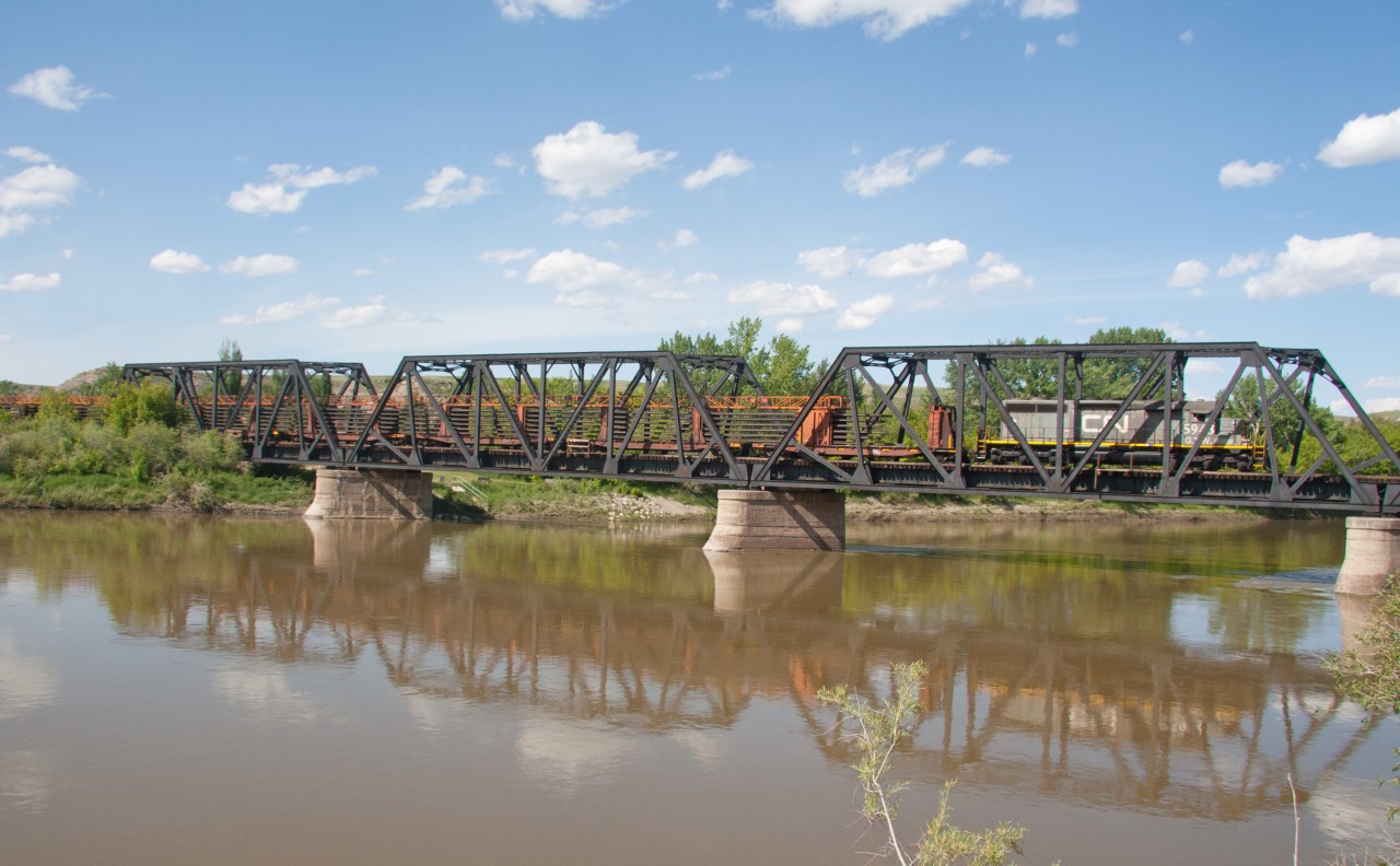 Another load of rail taken off the Drumheller Sub, crossing over the murky Red Deer River. Train will stop in the town for the night before heading west to Calgary.