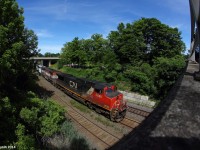 CN train 435 slowly rumbles past the 20th annual meet-up at the Bayview Jct pedestrian bridge with a BCOL cowl in the trail. The perfect light gave me an opportunity to get this neat composition with my 8mm lens, the pedestrian bridge being to the right and the train to the left.