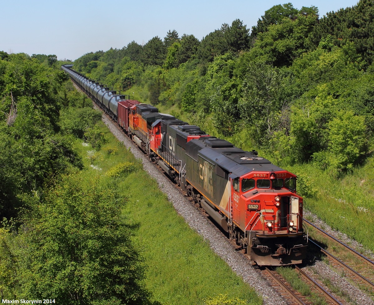 Thanks goes to a few people for the heads up, you know who you are. CN 710 with a lashup you don't see everyday, a SD60F, a SD60, and a BNSF! Just before it was high sun, CN 710 comes rolling by.