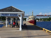 A NB CP train cruises over the Parry Sound trestle hauling intermodal containers. The Parry Sound docks are seen to the left.