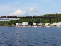 The last train of the day, CN 303 heads through the small town of Parry Sound, ON. The Canadian Pacific trestle, built in the early 1900's, stretches over 1,000 feet long and can be seen from most areas of Parry Sound. This particular photo is taken from the dock where the lighting is perfect in the evenings for the northbounds. 