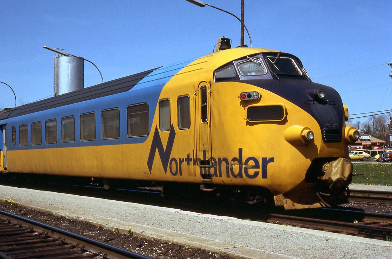 A closeup shot of the rear car of Swiss-built TEE trainset ONT 1987 (more specifically end cab coach car 1987-4) seen here operating on Ontario Northland's Northlander at Washago ON. Built for bidirectional operation, the cabs in these were infrequently used, if ever (the FP7's that replaced the original power cars always lead). Also note the rear coupler covered and out of use, likely the original non-compatible rear coupler the trainsets came with and retained.For an overview of the entire train at the station: http://www.railpictures.ca/?attachment_id=14873