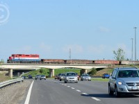 GEXR 582 is returning from Galt on the Fergus spur with dimensional load spacers (filled with ballast) and a dimensional load (out of sight) from Innovative Steam Technologies. Seen crossing the "Hanlon Expressway - Highway 6" in Guelph.
