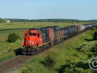 We're at the now-outskirts of Milton and I'm standing on a new road  and overpass risen from the earth - the fields at left, and right of me are slated to become cookie cutter housing. I'm sure there will be plenty of gas stations, boston pizzas, wild wings, and walmarts to go along with the beautiful escarpment and rapidly dissapearing farmland, oh boy I can't wait! Get your shots while you still can!<br><br>L570 is returning from Paris with a cut of cars after delivering empty autotracks for Beachville. GTW 4915 is in the lead due to no place to wye (Paris restricted to four axle and may be spiked).